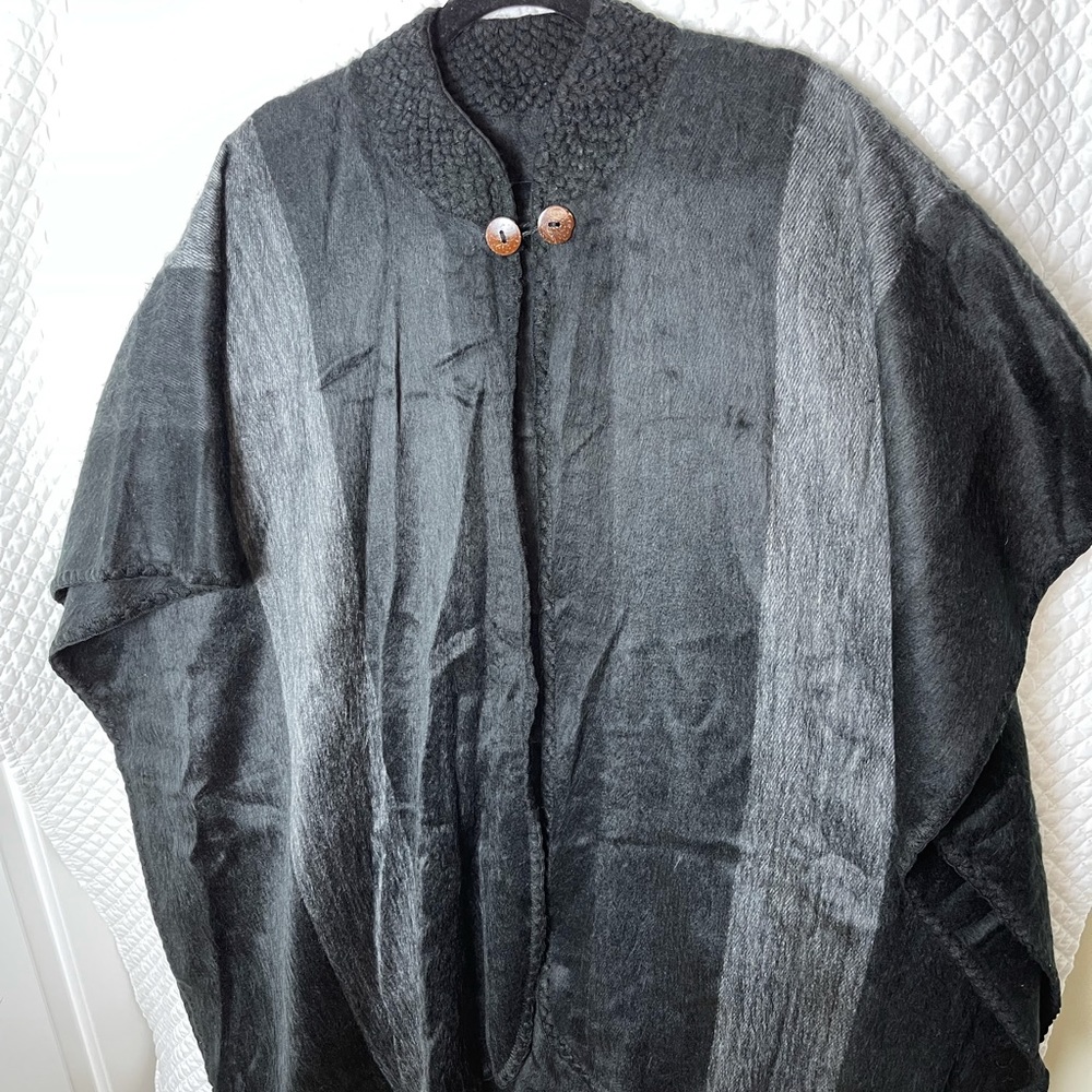 Gorgeous barely worn black poncho. So soft! Crocheted neck. Wooden buttons clasp